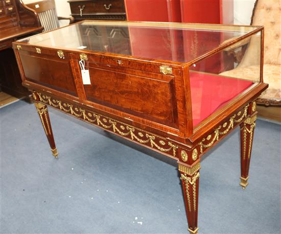 A mahogany display case on an ornate ormolu mounted base, W.138cm D.63cm H.92cm
